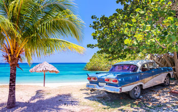 Vintage american oldtimer car parked on a beach in Cuba (Photo via Delpixart / iStock / Getty Images Plus)
