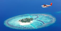 Sea plane flying above Maldives islands, Raa atol (photo via Jag_cz / iStock / Getty Images Plus)