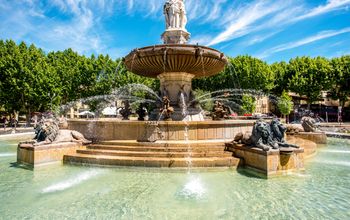 The Fontain de la Rotonde with three sculptures of female figures presenting Justice in Aix-en-Provence in France (photo via RossHelen/iStock/Getty Images Plus)