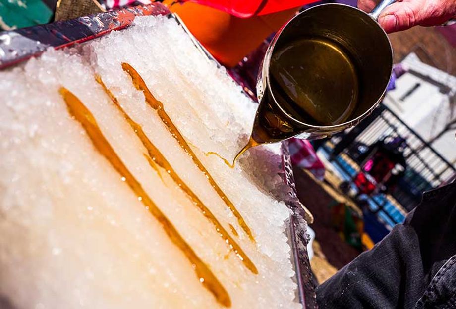 Frozen maple taffy on snow is one of the rustic culinary delights visitors to a traditional Québecois cabane à sucre (sugar shack) can enjoy.