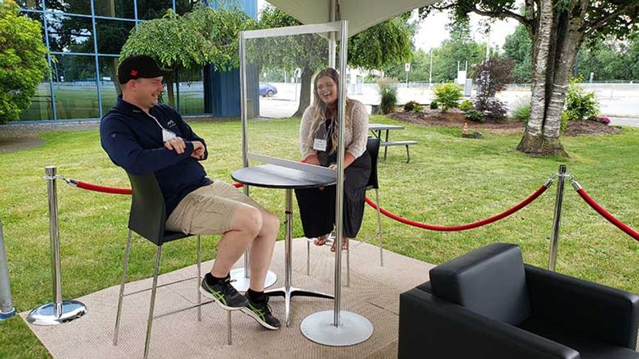 Attendees of the June Social could chat at socially distanced high-top tables, complete with Plexiglass guards.