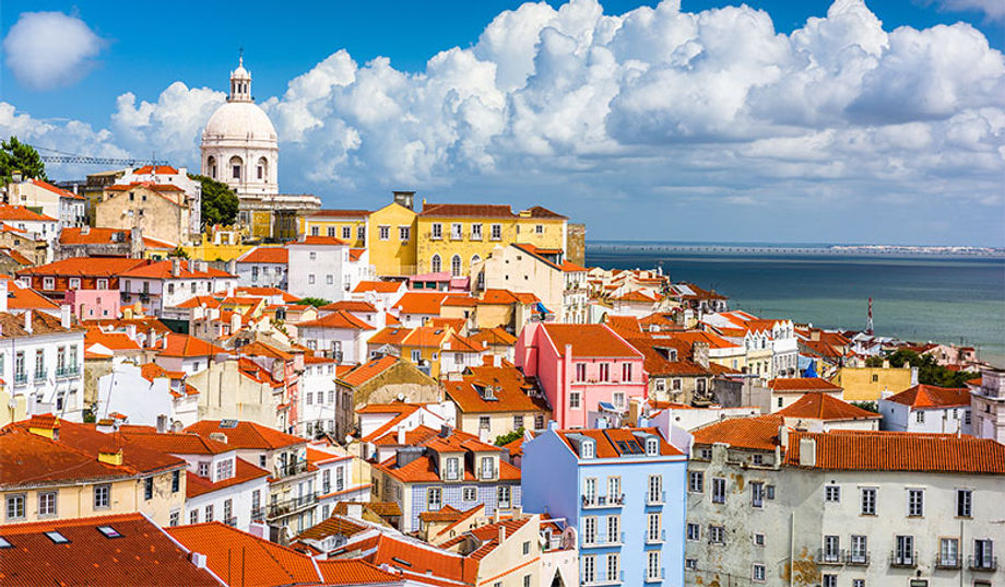 Colorful Lisbon, Portugal, slopes down into the Tagus Estuary.