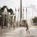  alt='kid running through a fountain in a european city'  Title='kid running through a fountain in a european city' 