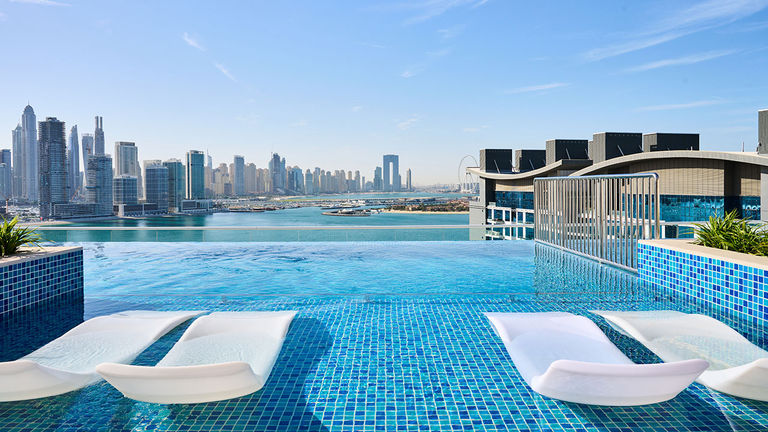 NH Collection Dubai The Palm's rooftop pool features stunning views.