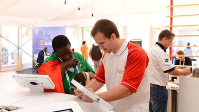 Indaba attendees browse on Samsung tablets in the event's TechZone. // © 2015 Reg Caldecott/South African Tourism