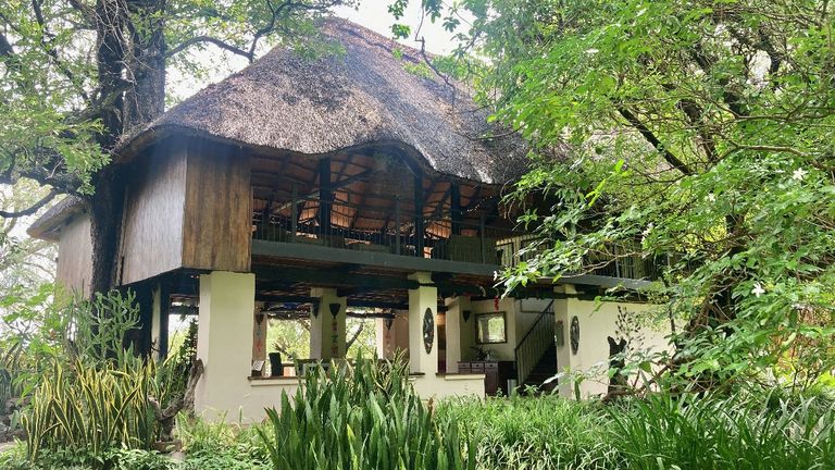 The dining room and upstairs lounge at the elegant Waterberry Zambezi Lodge are surrounded by lush gardens on the banks of the Zambezi River.