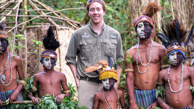 Ian Swain II, marketing manager for Philadelphia-based Swain Destinations, with villagers in Papua New Guinea // © 2014 Ian Swain II