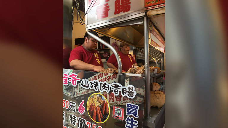 The long queue is worth the wait for the food stall at the end of Old Street, which offers tasty boar sausages.