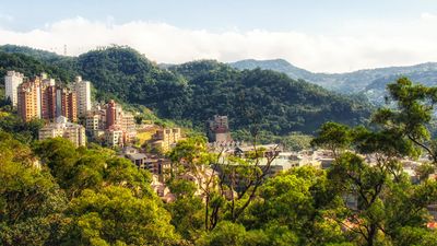 Mountains and rolling green hills surround Taipei.