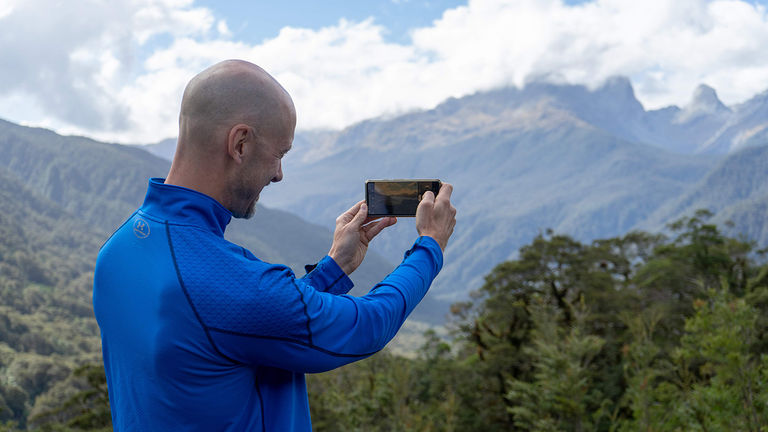 The writer pauses to take a photo of New Zealand’s landscape.