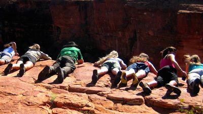 Hikers look down into Kings Canyon while trekking with Wayoutback Australian Safaris. // © 2015 Shane Nelson
