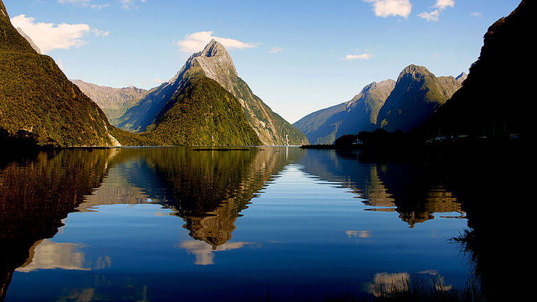 The mountains surrounding Milford Sound create a lovely reflection on the water.