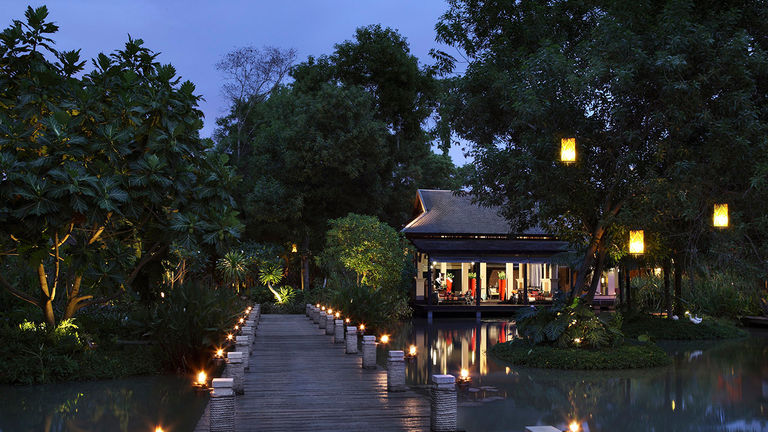 An expansive platform stretches over a lagoon and leads to the hotel’s lobby.
