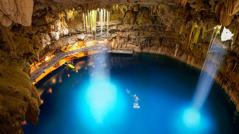 Clients can explore Chukum-Ha by rappelling into the cenote.