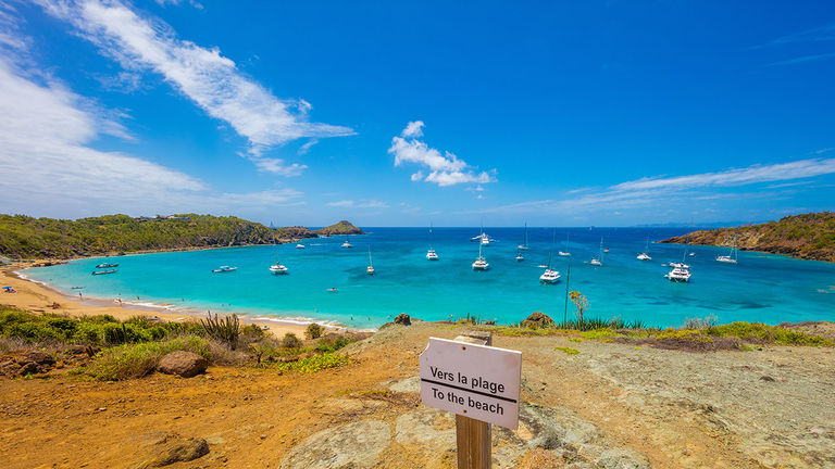 Colombier Beach is accessible via boat; adventurers can opt to hike down to from a scenic overlook.