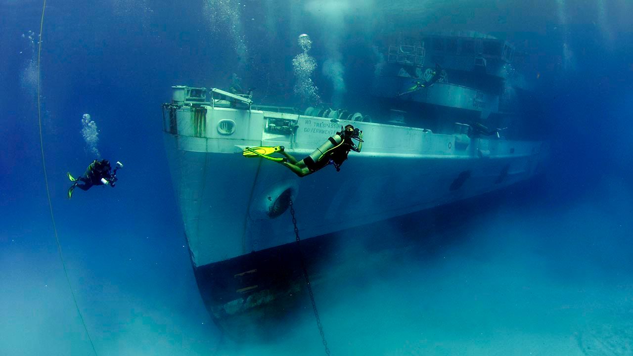 Clients can explore the USS Kittiwake, a former U.S. Navy submarine rescue ship, during night dives.