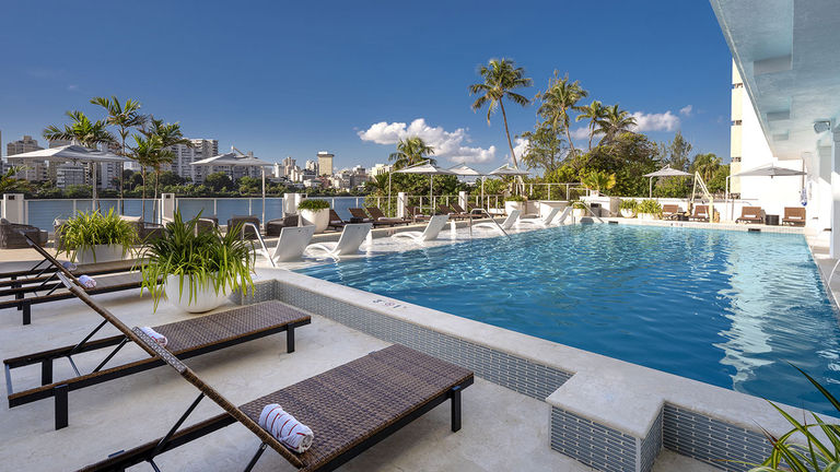 Clients can sunbathe by the pool in inviting loungers.