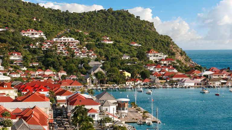 Hotel Barriere Le Carl Gustaf Saint-Barth overlooks the bustling harbor in the city of Gustavia.