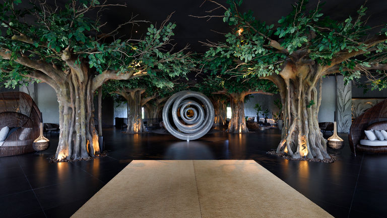 Contemporary tree installations greet guests in the lobby of Lopesan Caoba Lagoona Resort, Spa & Casino.