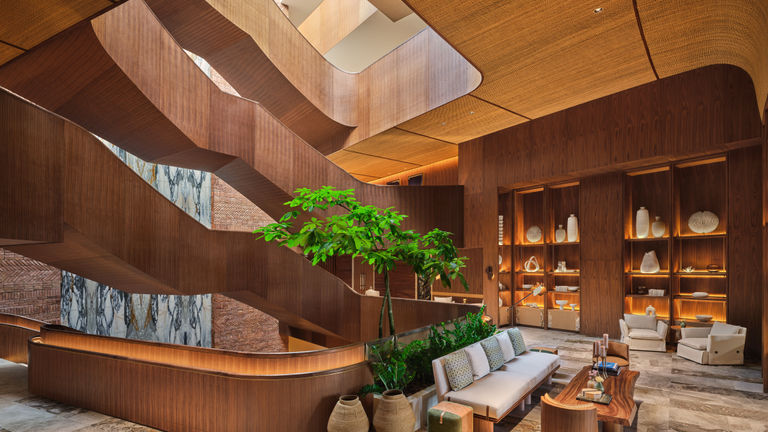 The lobby houses a curated art collection and a “dancing staircase.”