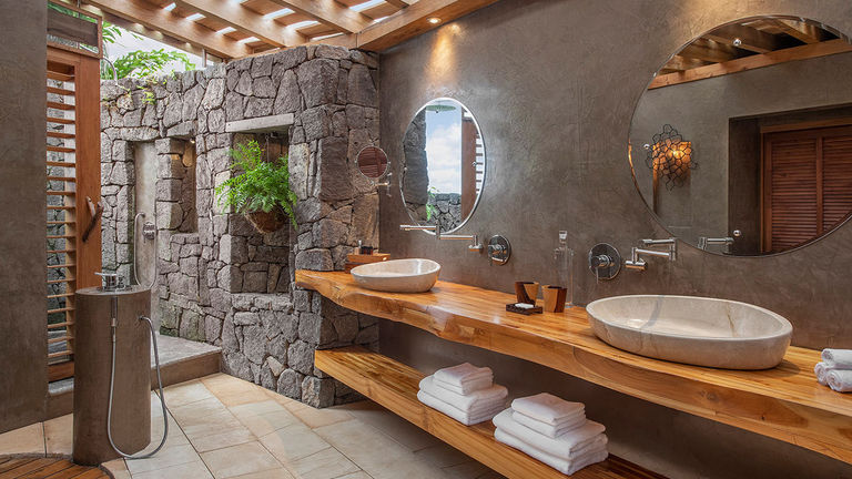 Guest bathrooms offer a stunning wall-less rainshower concept as well as access to an outdoor shower.