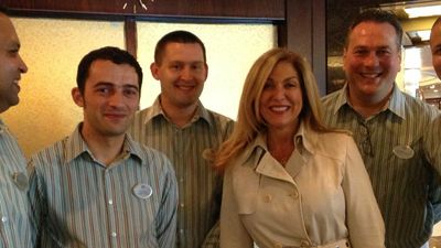 New president and COO of Crystal Cruises Edie Bornstein poses with members of the Crystal crew. // © 2013 Crystal Cruises F
