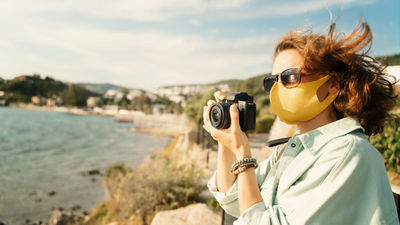 Cruise lines will mandate the use of face masks in indoor spaces and outdoors when social distancing is not possible.