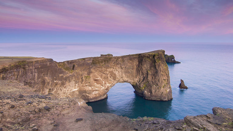 The arches of Dyrholaey were formed by natural erosion and are located on the south coast of Iceland.