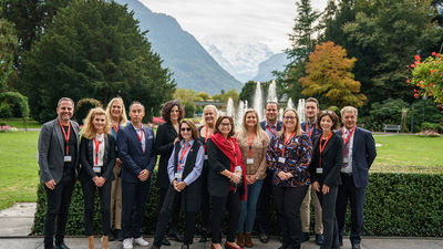 Members of the North American cohort pose in front of Interlaken’s breathtaking backdrop at STM 2021.