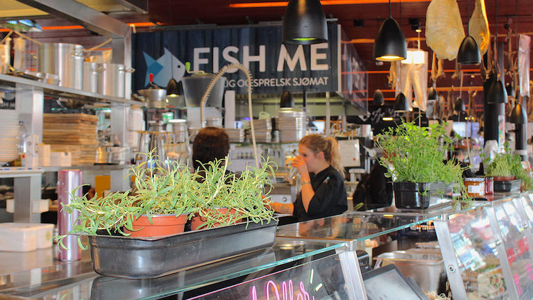 Fish Me features a warm, welcoming ambiance and comfortable indoor seating in the city’s fish market.