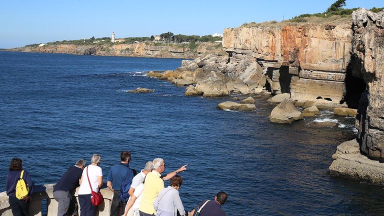 Walk along the boardwalk of Boca do Inferno.