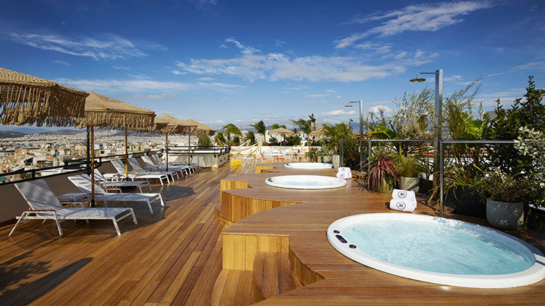 Brown Acropol has a rooftop sundeck with loungers, hammocks and three outdoor hot tubs.