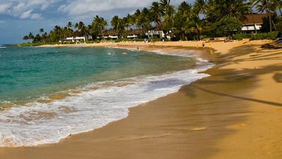 Skimboarding at Poipu Beach on Kauai’s south shore may be fun, but visitors should also be cautious. // © 2014 HTA/Tor Johnson 2