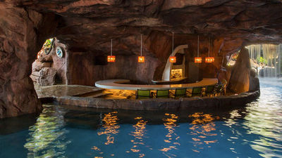 Hyatt Maui guests can swim right up to the cave-like Grotto Bar, tucked away beneath waterfalls. // © 2015 Hyatt Regency Maui Resort and Spa