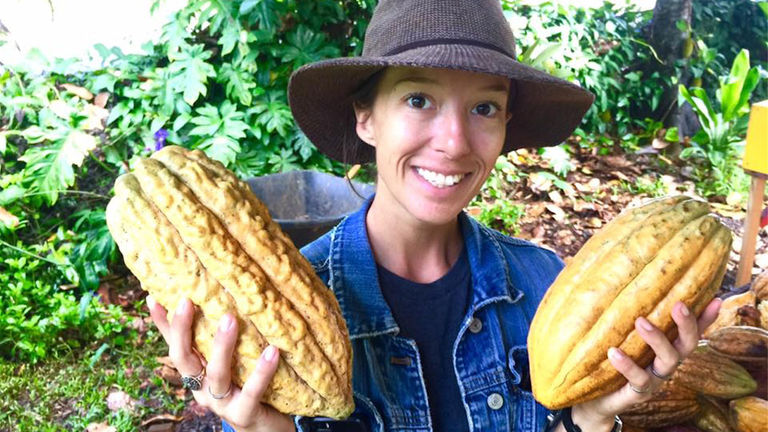 Angie Villa displays freshly harvested cacao pods at Garden Island Chocolate.