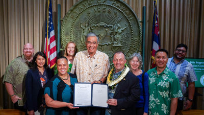 Hawaii lawmakers and tourism stakeholders joined Governor Josh Green at a signing ceremony June 28 for new sustainable tourism legislation.