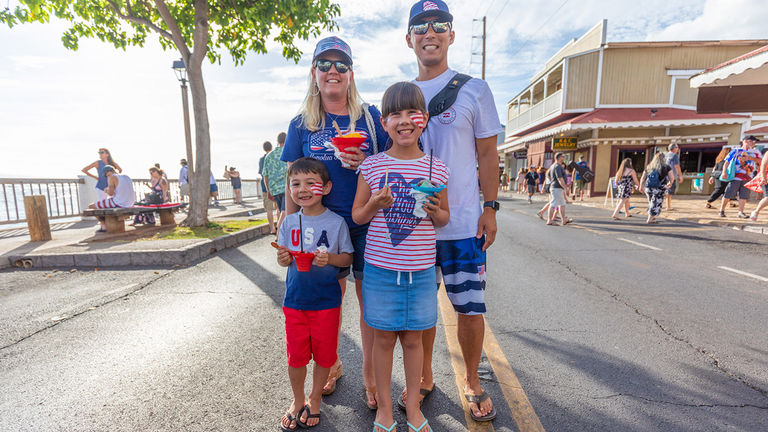 During the July 4 festivities in Lahaina, Maui, a family celebrates with face paint and Hawaiian shave ice.