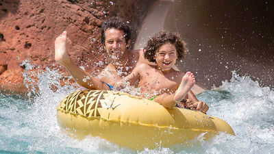 On Aulani's 204-foot-long Tubestone Curl slide, inflatables help guests share the splashy experience. // © 2017 Disney