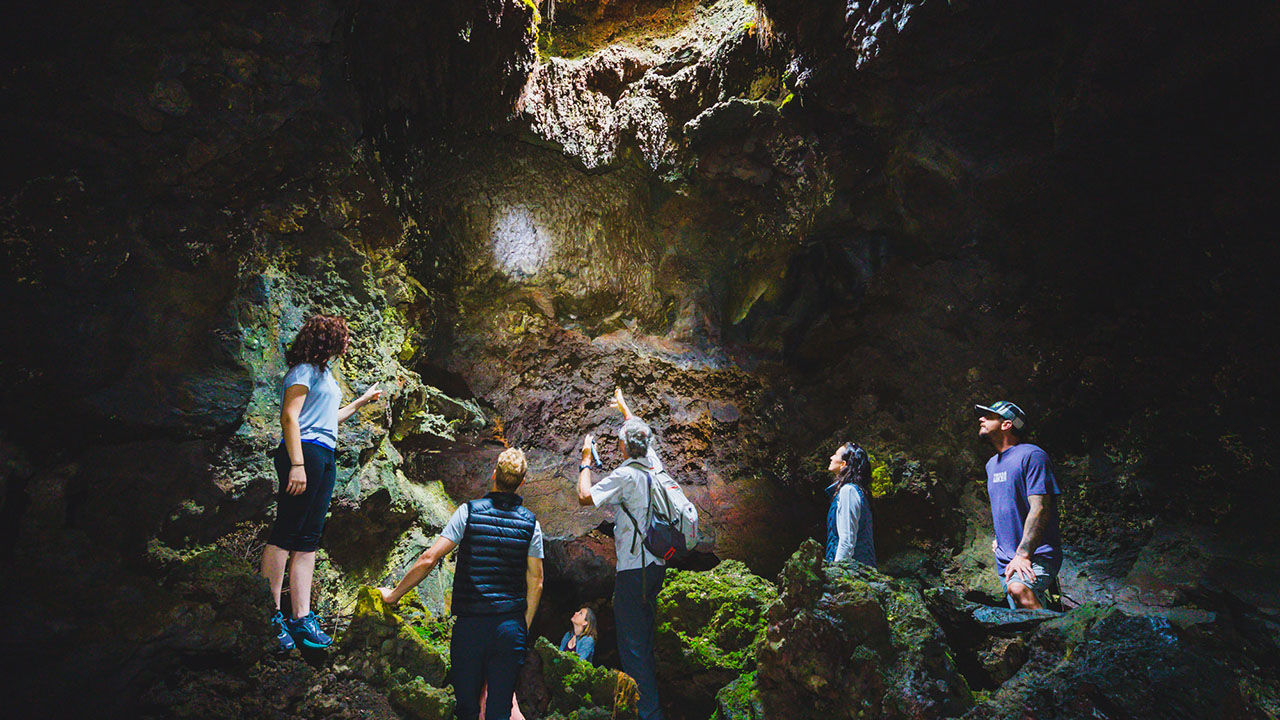 During Hawaii Forest & Trail's tour of Hualalai volcano, guests descend into a lava tube.