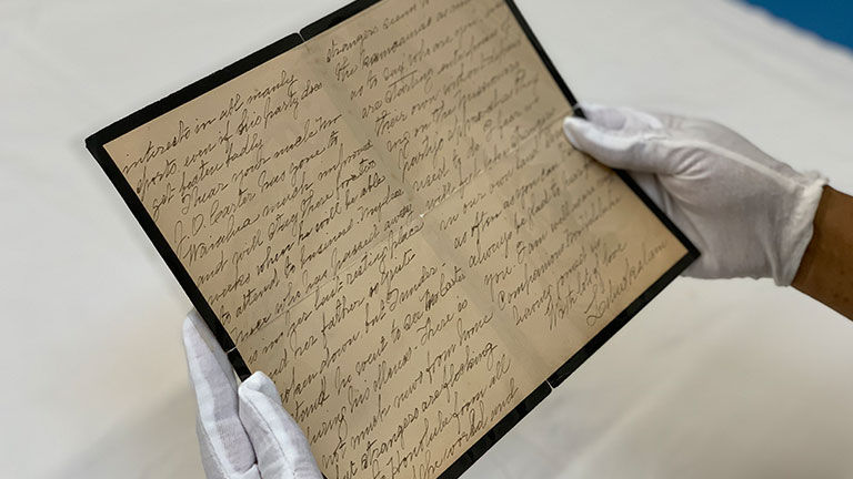 One of the items clients might hold during the White Glove Tour is a letter Queen Liliuokalani wrote.