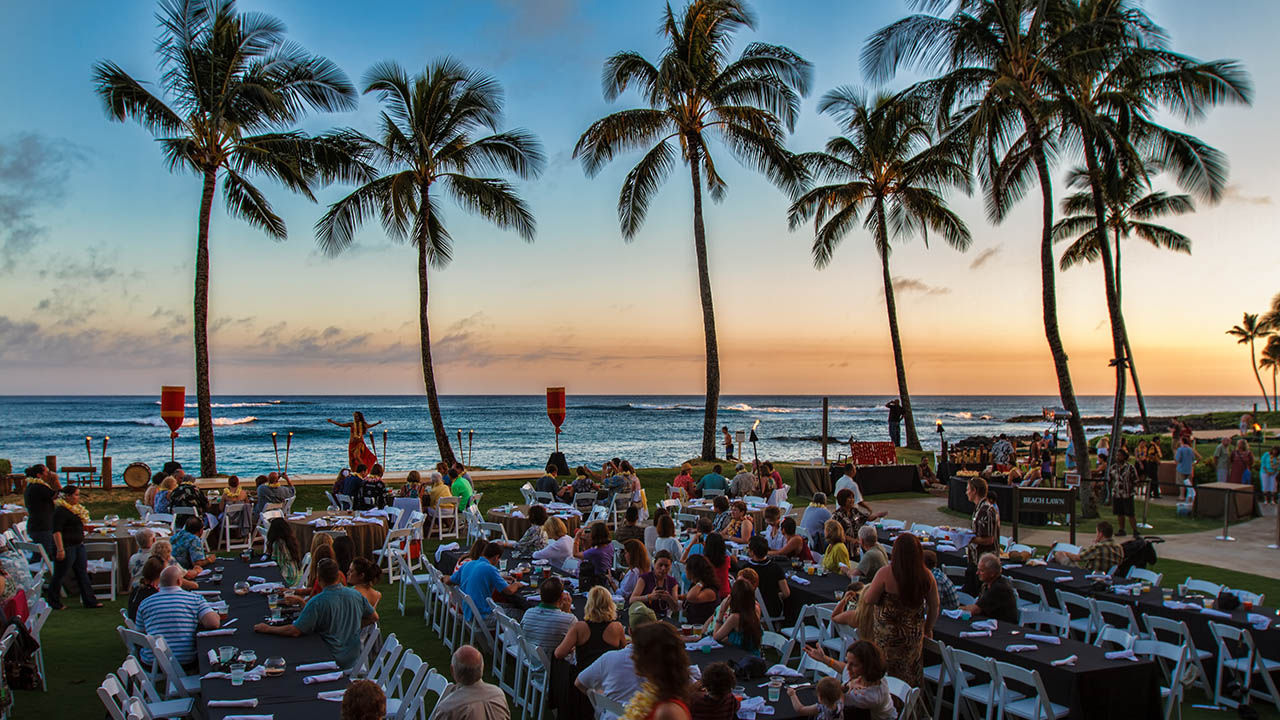 The golden glow of sunset provides a dreamy backdrop for Aulii Luau, at Sheraton Kauai.