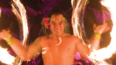 A fire-knife dance lights up the night at Grand Hyatt Kauai’s luau. // © 2015  Grand Hyatt Kauai Resort & Spa