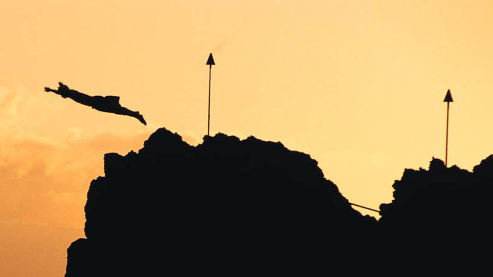 A cliff diver honors the last chief of Maui with a nightly sunset cliff dive off of Black Rock on Kaanapali Beach. // © 2013 Sheraton Maui Resort and Spa F