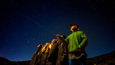 A Hawaii Forest & Trail guide points out constellations during the tour’s star show atop the summit of Maunakea.