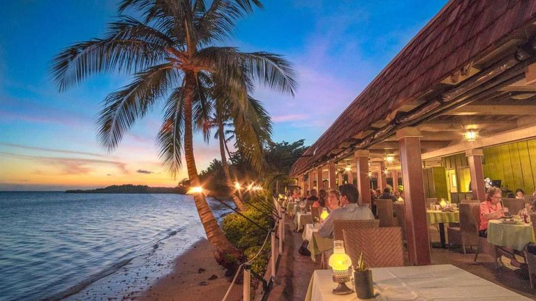 Guests of Hotel Molokai enjoy meals at an open-air, oceanside dining room.