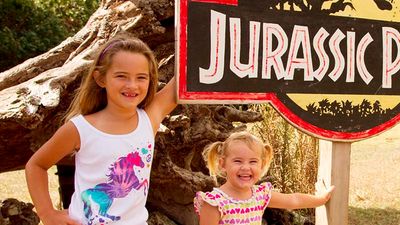 Young Kualoa guests pose by a fallen tree made famous in “Jurassic Park.” // © 2017 Kualoa Ranch