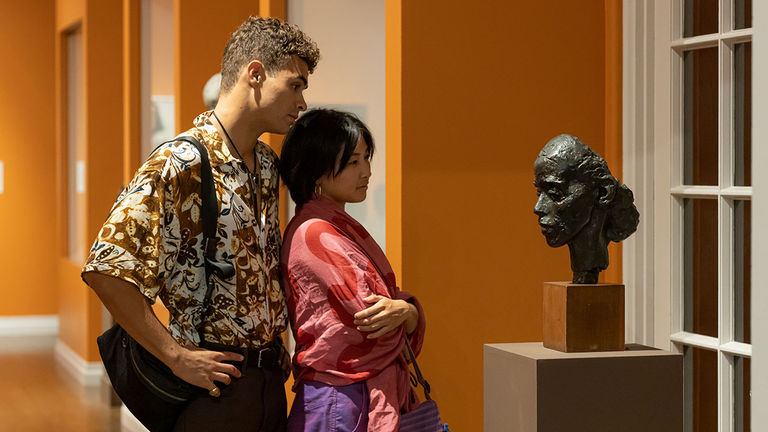 HoMA Night attendees admire a bust in the Portrait Gallery.