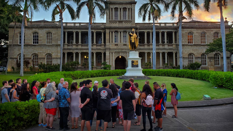 Lopaka Kapanui’s Ghosts of Old Honolulu Tour pauses in front of the famous statue of Kamehameha the Great in front of Aliiolani Hale in downtown Honolulu.