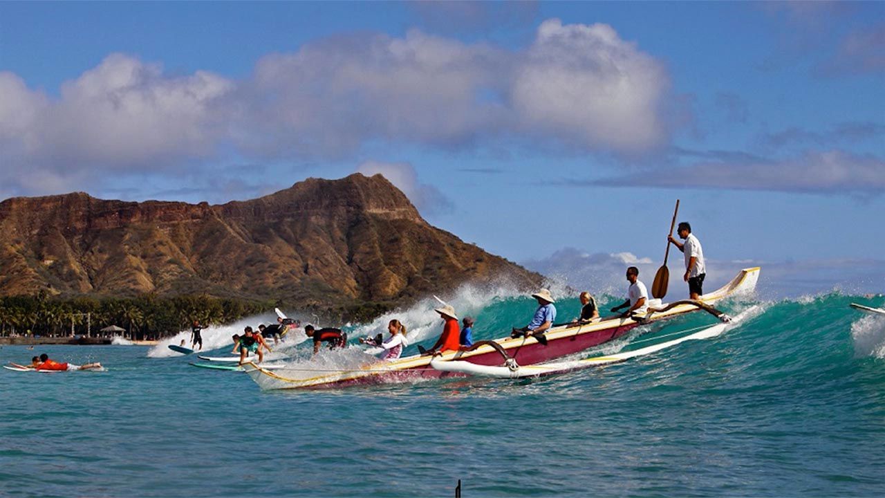 Clients work together for outrigger canoe thrills.