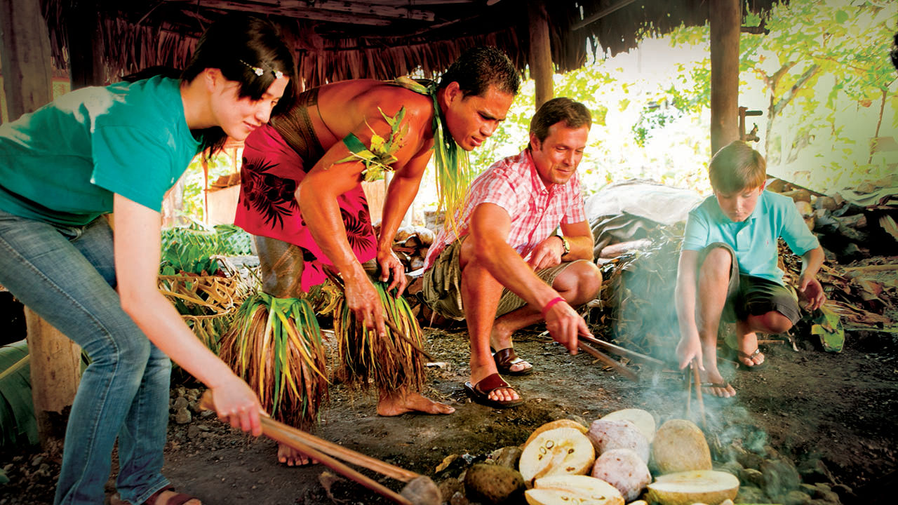 Everyone chips in to prepare and cook a traditional Samoan feast during the umu-making experience.